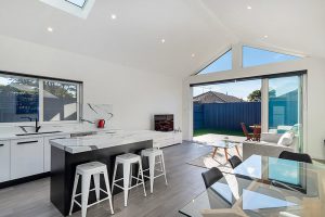 Modest exterior expansive interior Maroubra addition - kitchen to garden